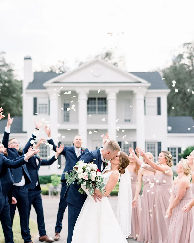 A wedding party tossing petals