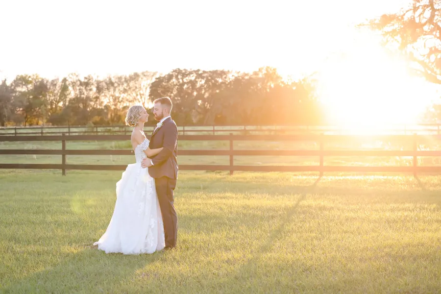 A couple in the field at sunset